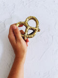 Brass pretzel bottle opener