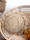 Round fringed raffia cushion